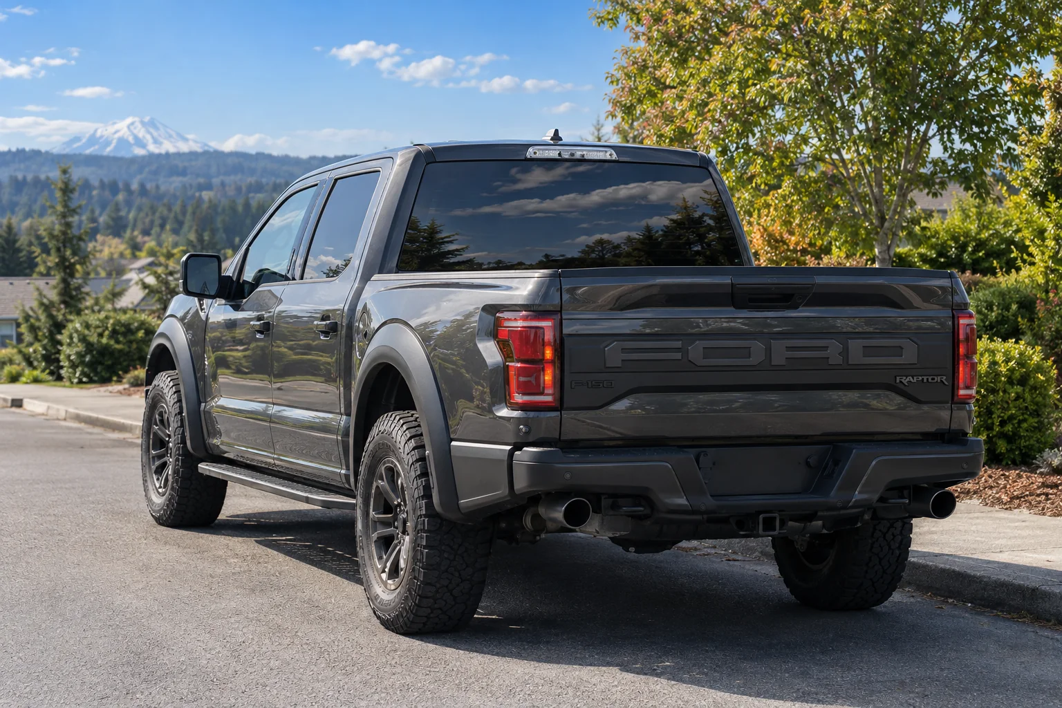 The tinted back window of a gray Ford F-150 Raptor