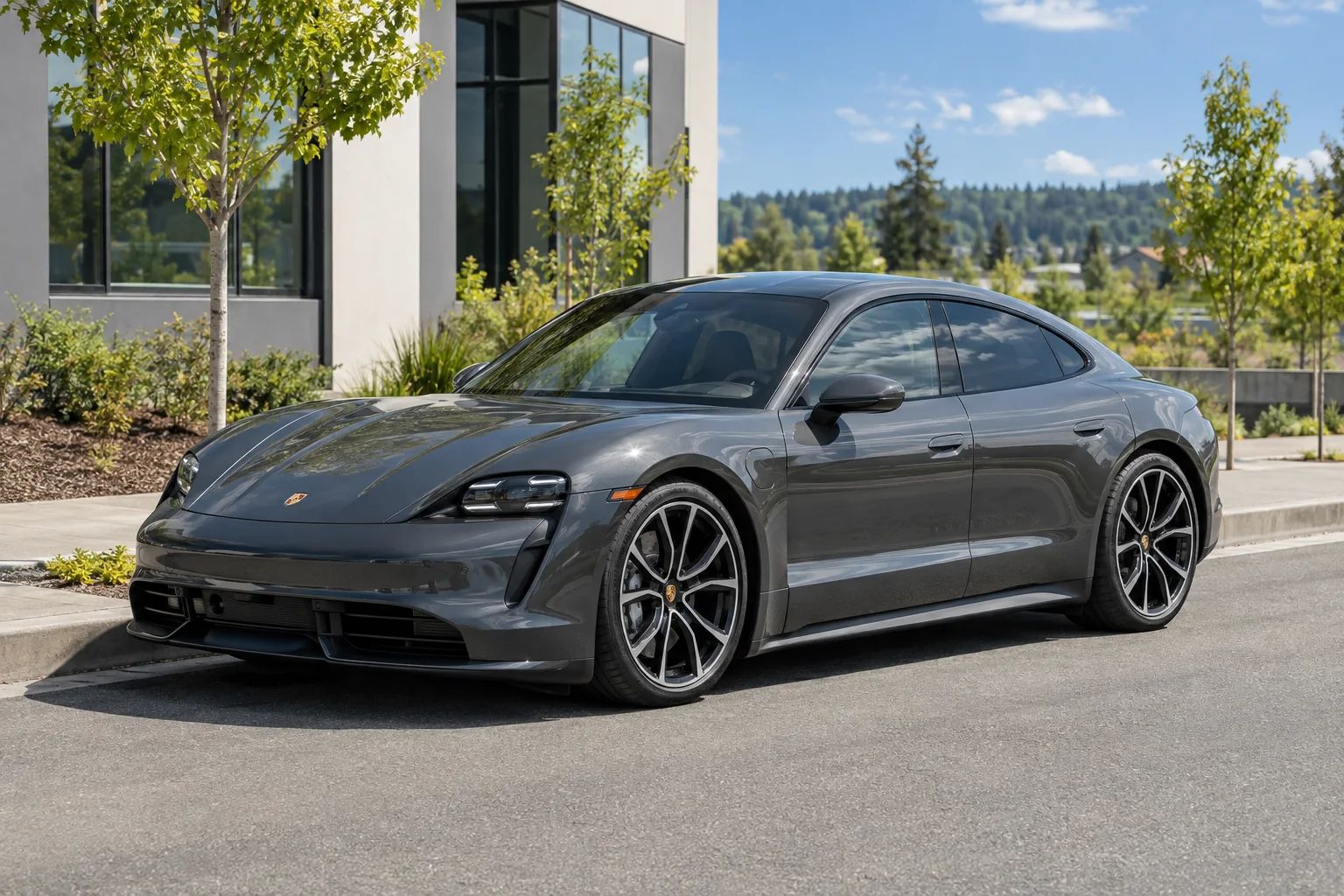 A gray Porsche Taycan with tinted windows in the sun
